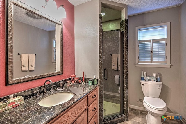 4701 Hickory Rd, Temple, TX 76502 - full bathroom with toilet, vanity, a stall shower, baseboards, and a textured ceiling