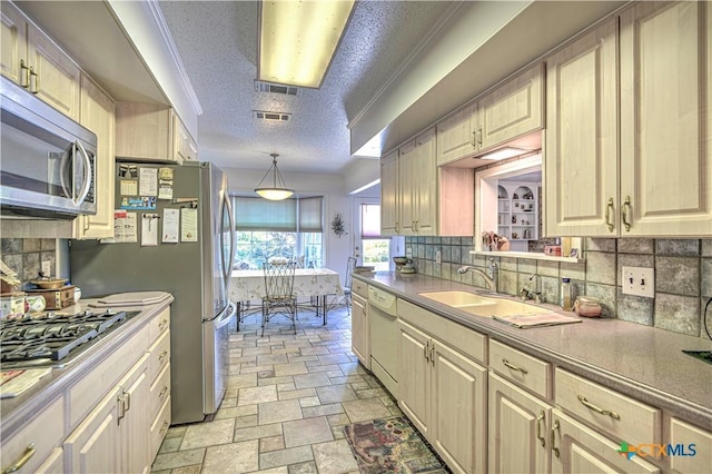 4701 Hickory Rd, Temple, TX 76502 - kitchen with appliances with stainless steel finishes, tasteful backsplash, a sink, light stone finish floors, and a textured ceiling