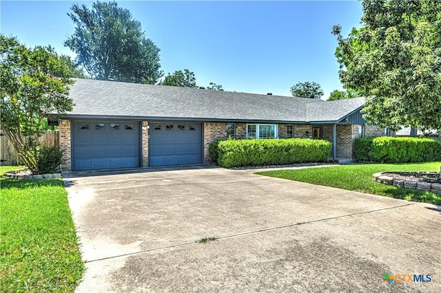 4701 Hickory Rd, Temple, TX 76502 - ranch-style home featuring brick siding, a garage, concrete driveway, and roof with shingles