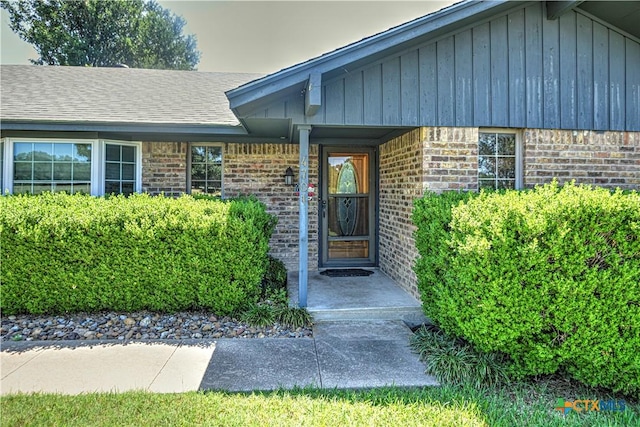 4701 Hickory Rd, Temple, TX 76502 - entrance to property featuring board and batten siding, brick siding, a shingled roof, and a porch