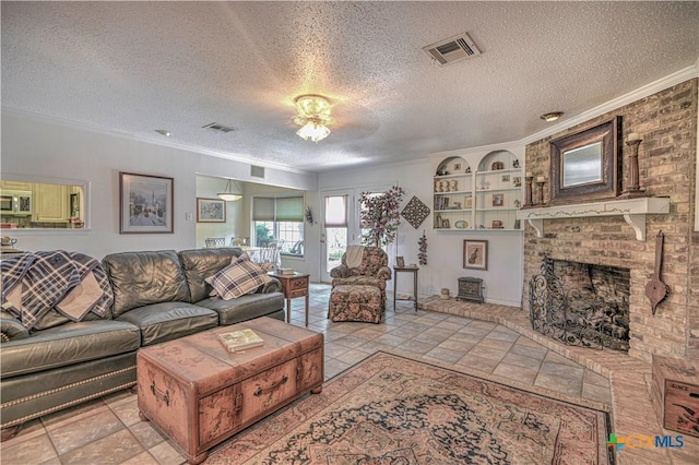 4701 Hickory Rd, Temple, TX 76502 - living area featuring crown molding, a textured ceiling, a brick fireplace, and built in shelves