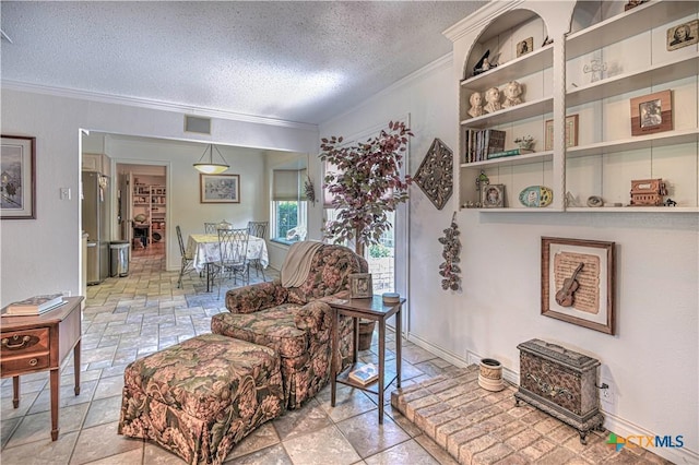 4701 Hickory Rd, Temple, TX 76502 - living room featuring ornamental molding and a textured ceiling