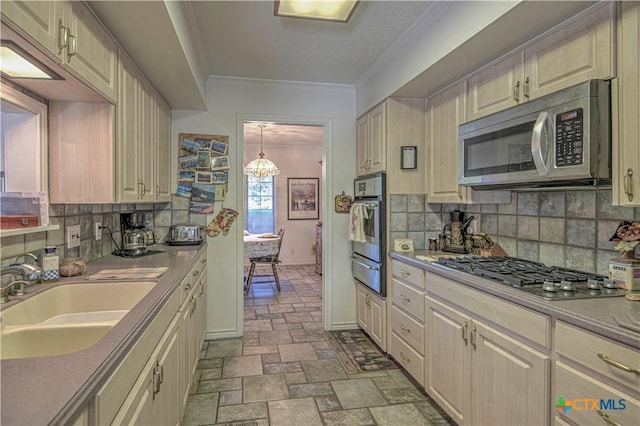 4701 Hickory Rd, Temple, TX 76502 - kitchen featuring stainless steel appliances, a sink, a warming drawer, ornamental molding, and tasteful backsplash