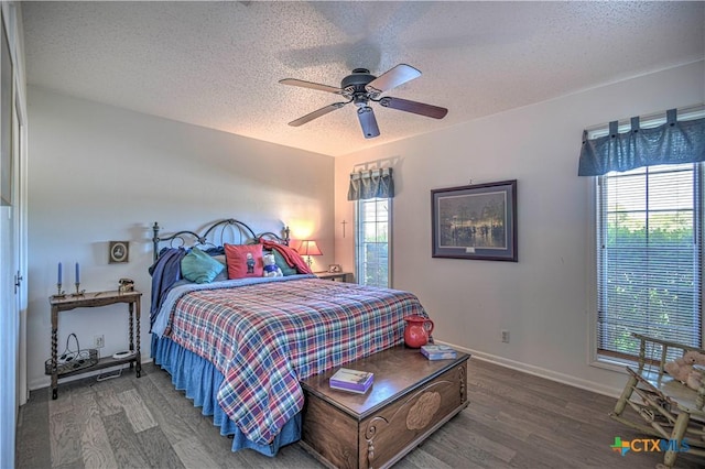 4701 Hickory Rd, Temple, TX 76502 - bedroom featuring wood finished floors, a textured ceiling, multiple windows, and baseboards