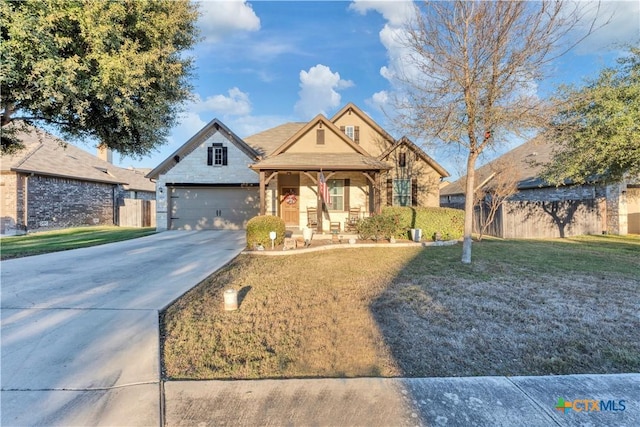 view of front of home featuring a porch, a garage, and a front yard