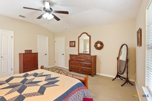 bedroom with vaulted ceiling, light carpet, baseboards, visible vents, and ceiling fan