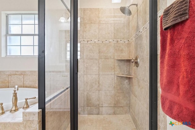 bathroom with a bath and a shower stall
