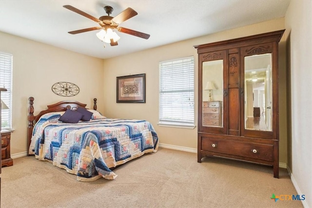 bedroom with baseboards, ceiling fan, and light carpet