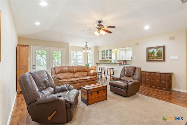living area with baseboards, wood finished floors, ceiling fan, and recessed lighting