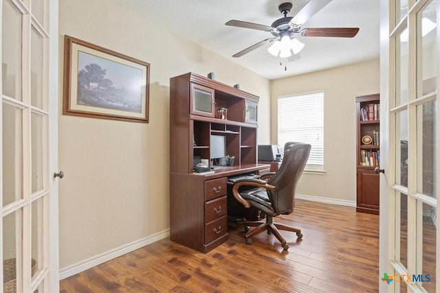 office space featuring baseboards, dark wood-style floors, french doors, and a ceiling fan