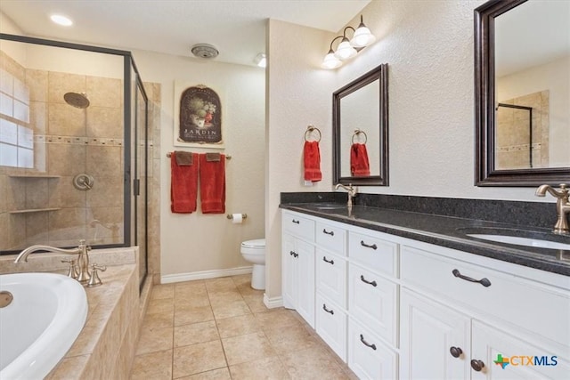 bathroom featuring a sink, a garden tub, and a shower stall