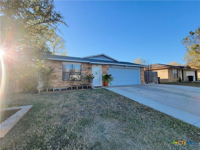 ranch-style home featuring a front yard and a garage