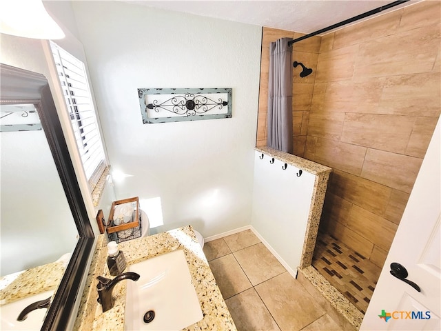 bathroom with vanity, tile patterned floors, and curtained shower