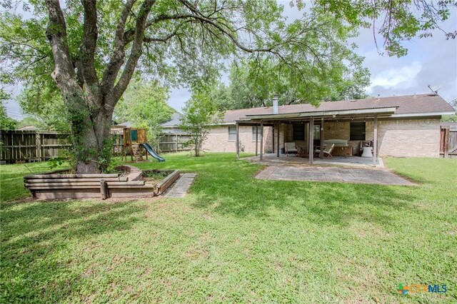 111 Lexington Ln, Victoria, TX 77901 - view of yard with a patio area, a fenced backyard, and a playground