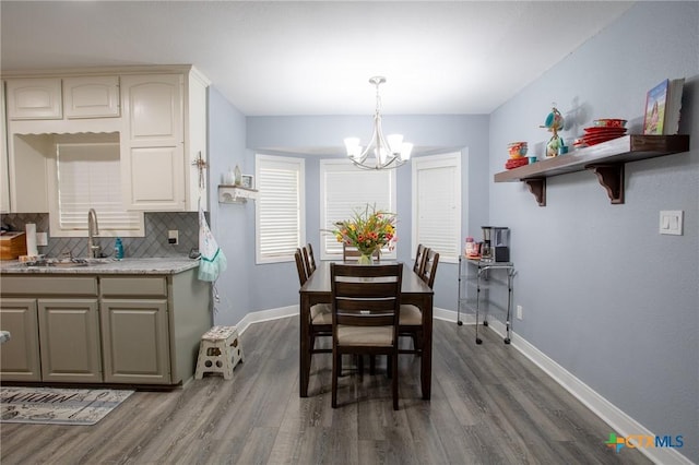 111 Lexington Ln, Victoria, TX 77901 - dining area featuring dark wood finished floors, baseboards, and a chandelier