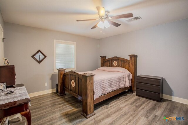 111 Lexington Ln, Victoria, TX 77901 - bedroom with wood finished floors, visible vents, a ceiling fan, and baseboards
