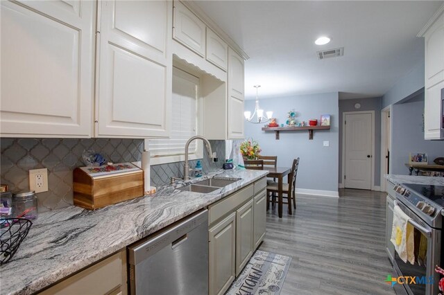 111 Lexington Ln, Victoria, TX 77901 - kitchen featuring tasteful backsplash, visible vents, stainless steel appliances, and a sink