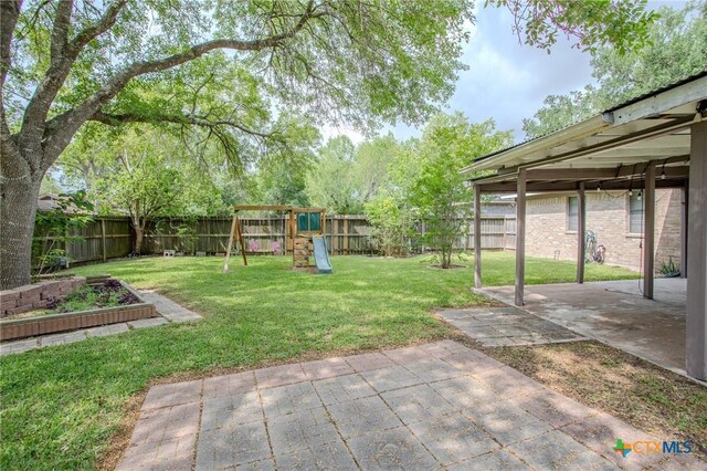 111 Lexington Ln, Victoria, TX 77901 - view of yard with a fenced backyard, a playground, and a patio