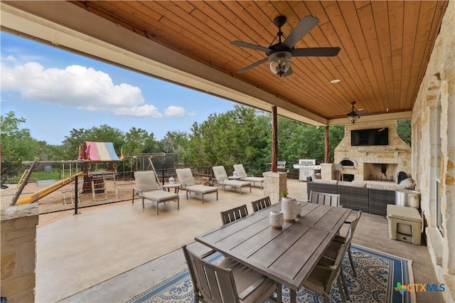 810 Pinnacle Pkwy, New Braunfels, TX 78132 - view of patio / terrace with a ceiling fan, a grill, an outdoor living space with a fireplace, and view of scattered trees