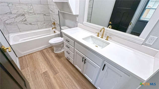 full bathroom with shower / bathing tub combination, vanity, toilet, and wood finished floors