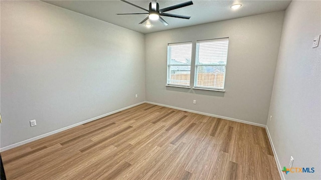 unfurnished room featuring light wood-type flooring, baseboards, and a ceiling fan