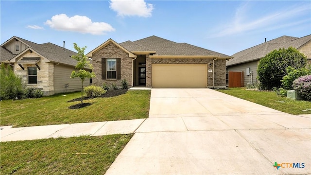 3938 Legend Park, New Braunfels, TX 78130 - view of front of house with an attached garage, brick siding, and driveway