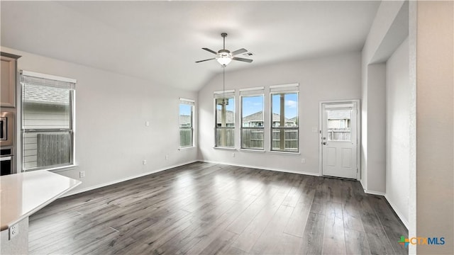 3938 Legend Park, New Braunfels, TX 78130 - unfurnished living room with a ceiling fan, dark wood finished floors, and vaulted ceiling