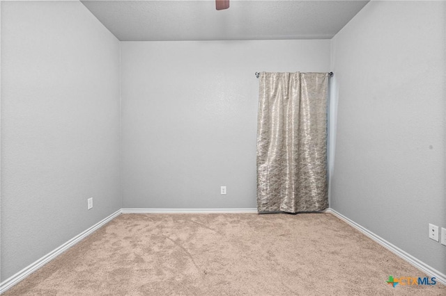 unfurnished room with ceiling fan and light colored carpet