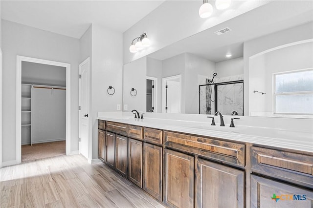 bathroom featuring vanity, hardwood / wood-style flooring, and walk in shower