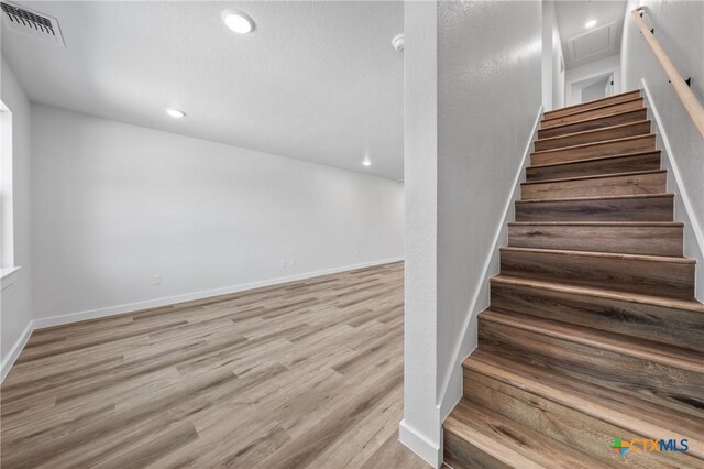 1013 S 26th St, Temple, TX 76501 - stairway with wood finished floors, recessed lighting, and baseboards