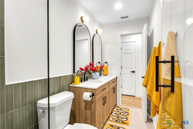 bathroom featuring wood-type flooring, vanity, and toilet