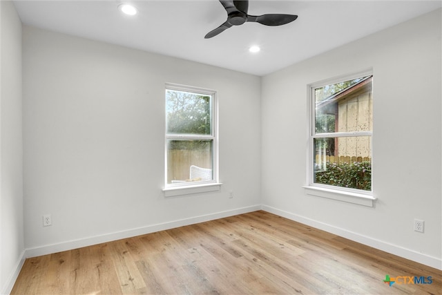 spare room with light wood-type flooring and ceiling fan