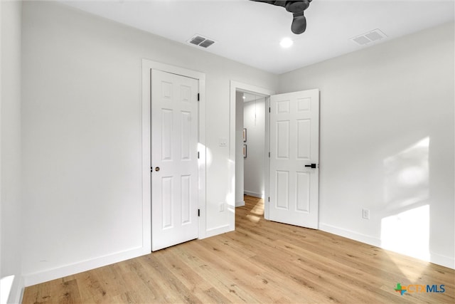 unfurnished bedroom with ceiling fan and light hardwood / wood-style floors