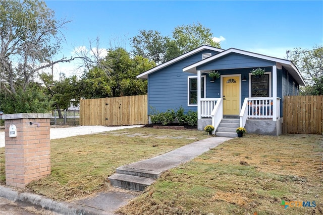 bungalow-style house featuring a front yard