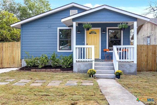 bungalow featuring a porch and a front yard