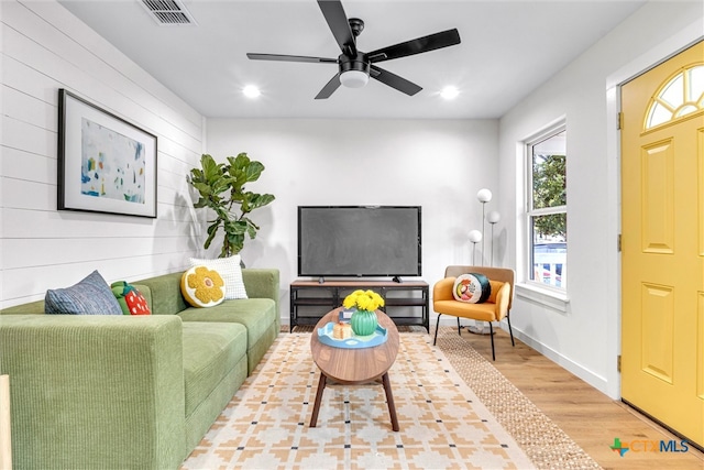 living room with hardwood / wood-style floors and ceiling fan