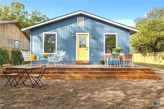 back of house featuring a wooden deck