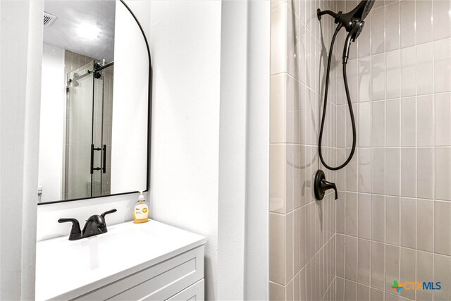 bathroom with vanity and an enclosed shower