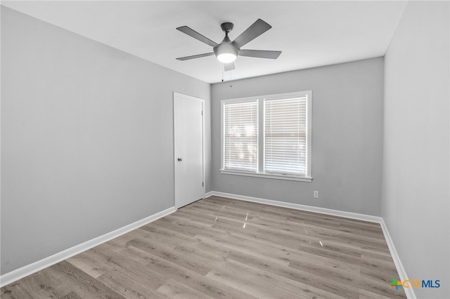 empty room featuring ceiling fan and light hardwood / wood-style floors