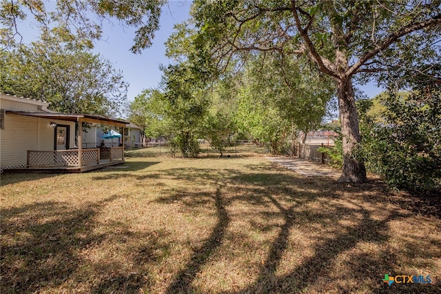 view of yard with a wooden deck