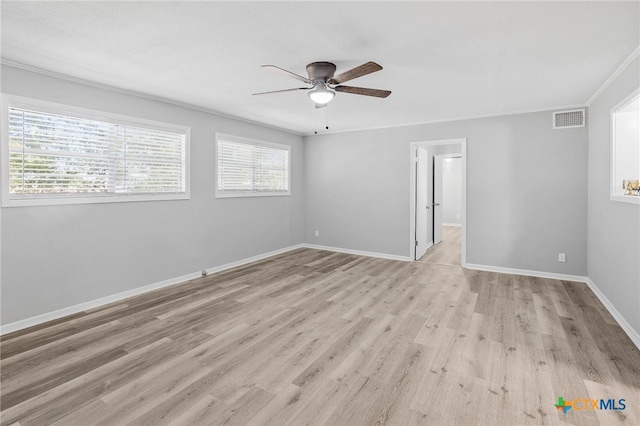 spare room with ceiling fan, light wood-type flooring, and crown molding