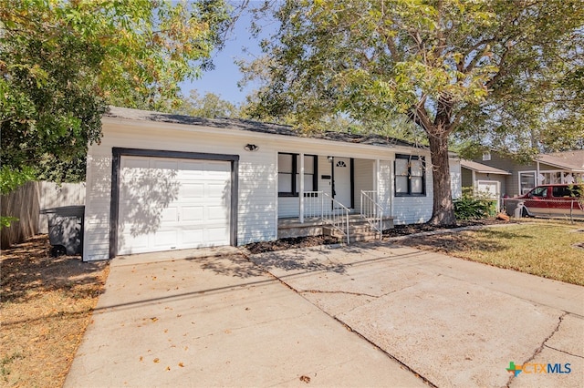 ranch-style house with a garage and covered porch