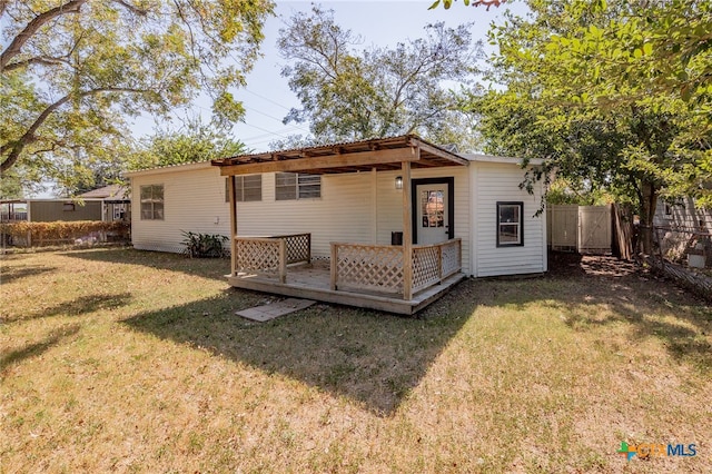 rear view of house featuring a yard