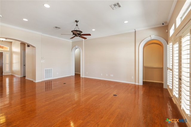 spare room featuring hardwood / wood-style floors, ceiling fan, and crown molding