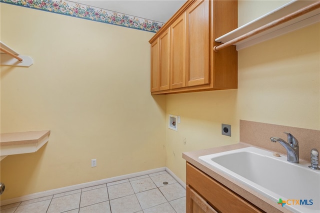 laundry area with light tile patterned flooring, washer hookup, cabinets, sink, and electric dryer hookup