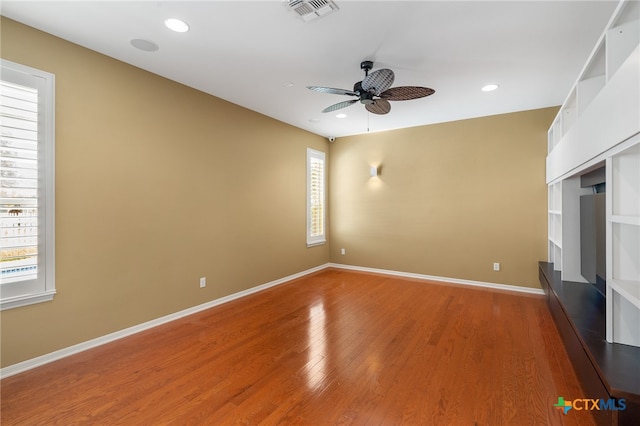 unfurnished room featuring hardwood / wood-style floors and ceiling fan