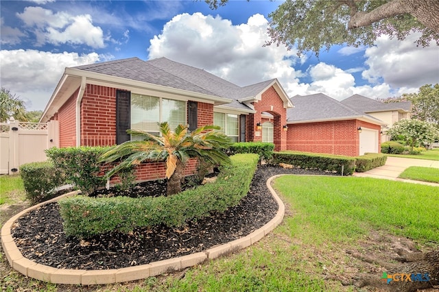 view of front of house with a front lawn and a garage