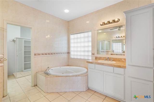 bathroom featuring tile patterned flooring, vanity, and tile walls