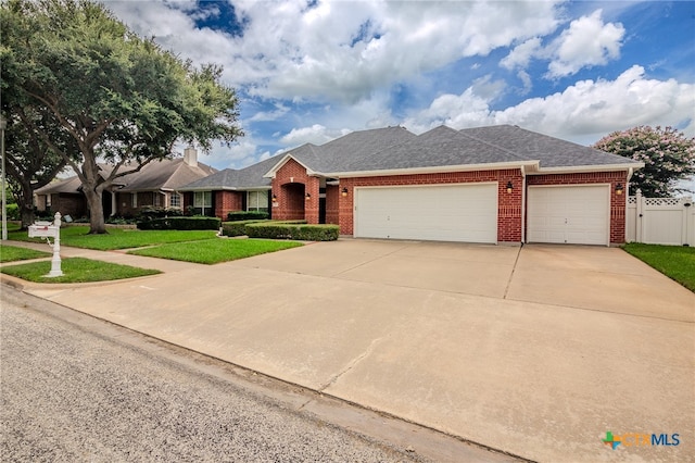 ranch-style home featuring a garage and a front yard