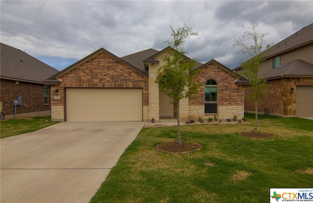 view of front of property with a garage and a front lawn